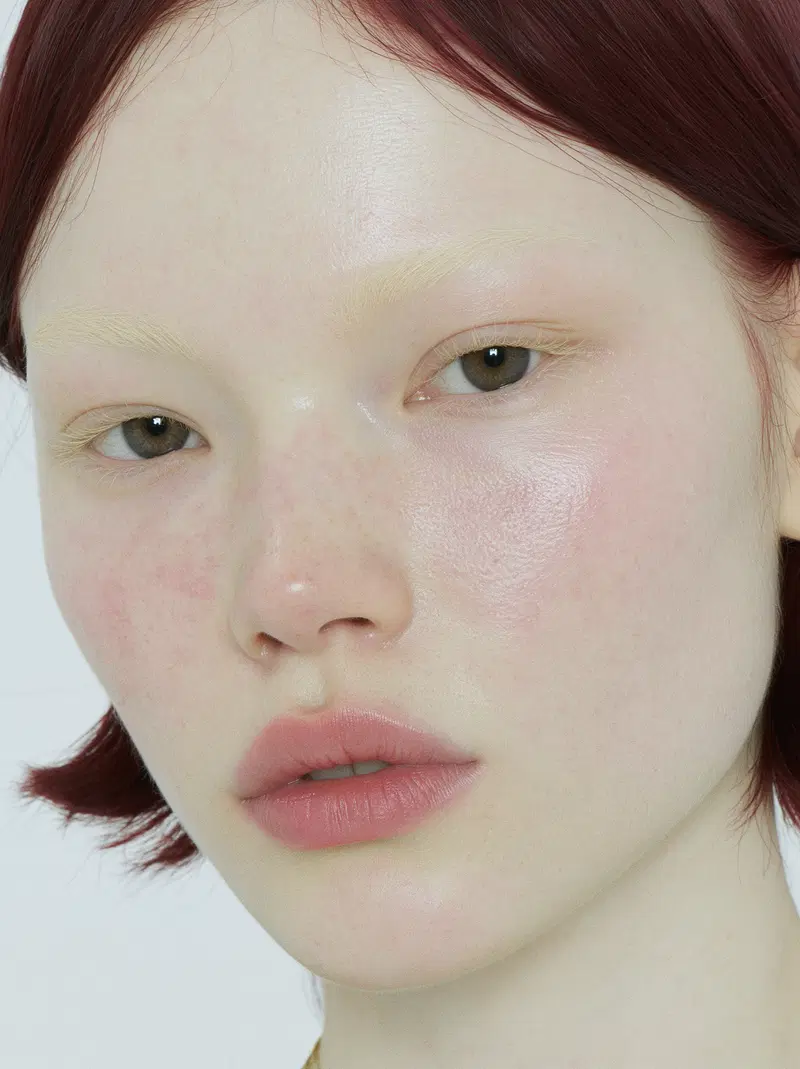 Close-up portrait of a person with pale skin and red hair