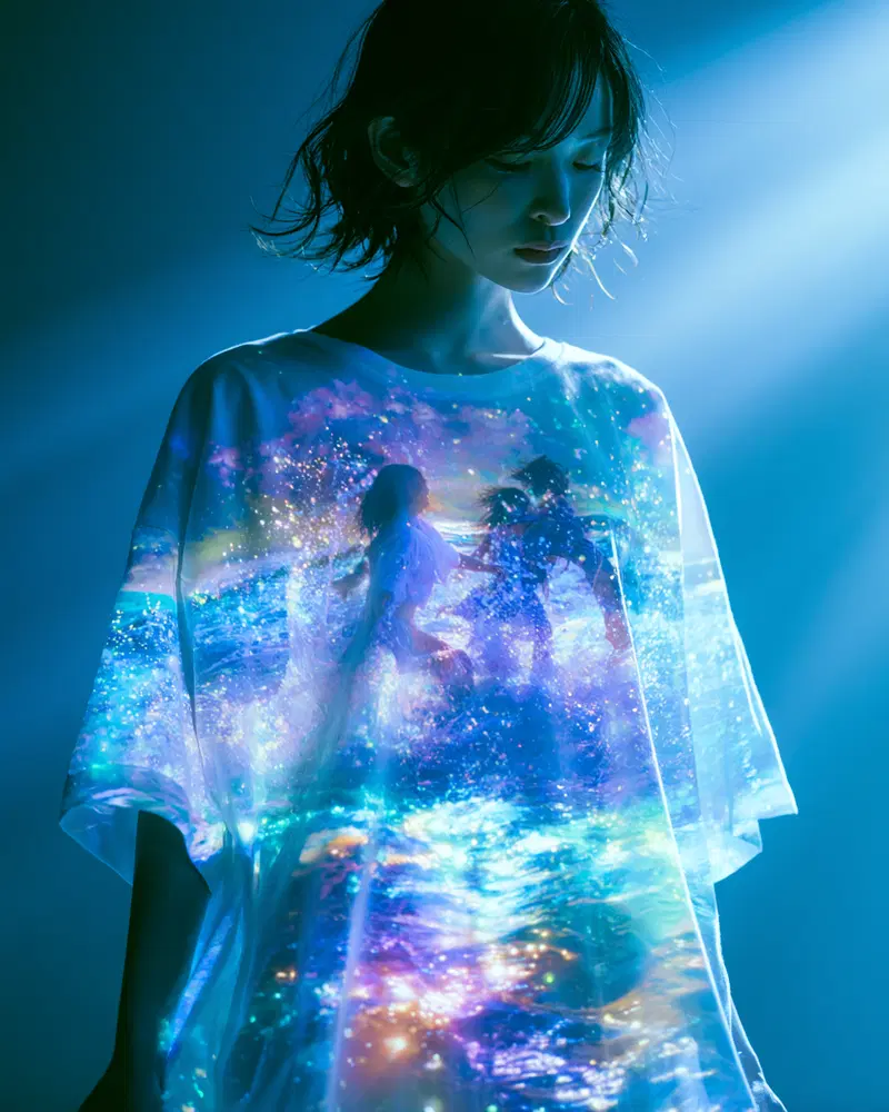 Digital art projection of fantasy scene on person in moody blue lighting