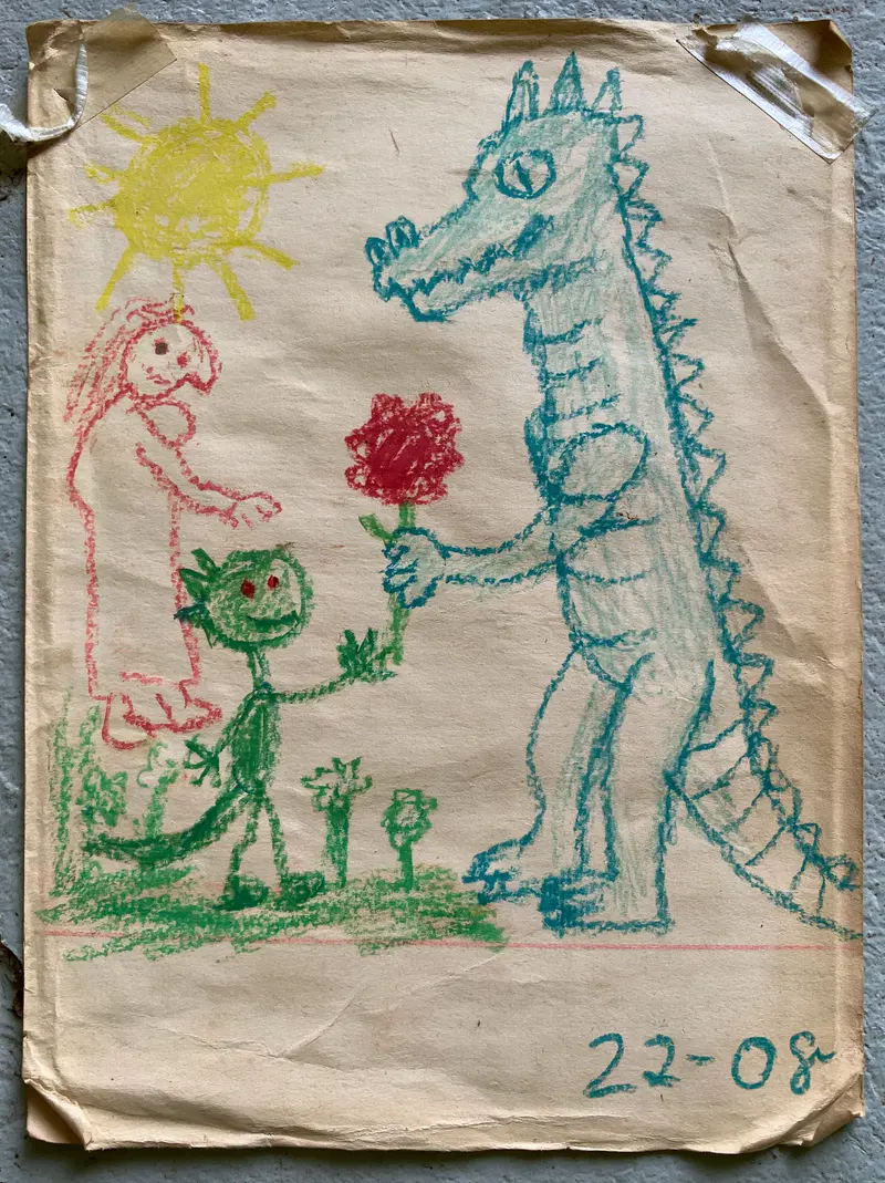 Childlike drawing of a green dragon giving a flower to a tall blue dragon with a person and sun in background