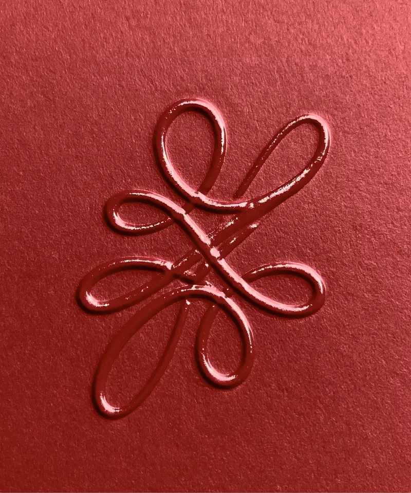 Elegant raised swirl design in rich red on textured paper
