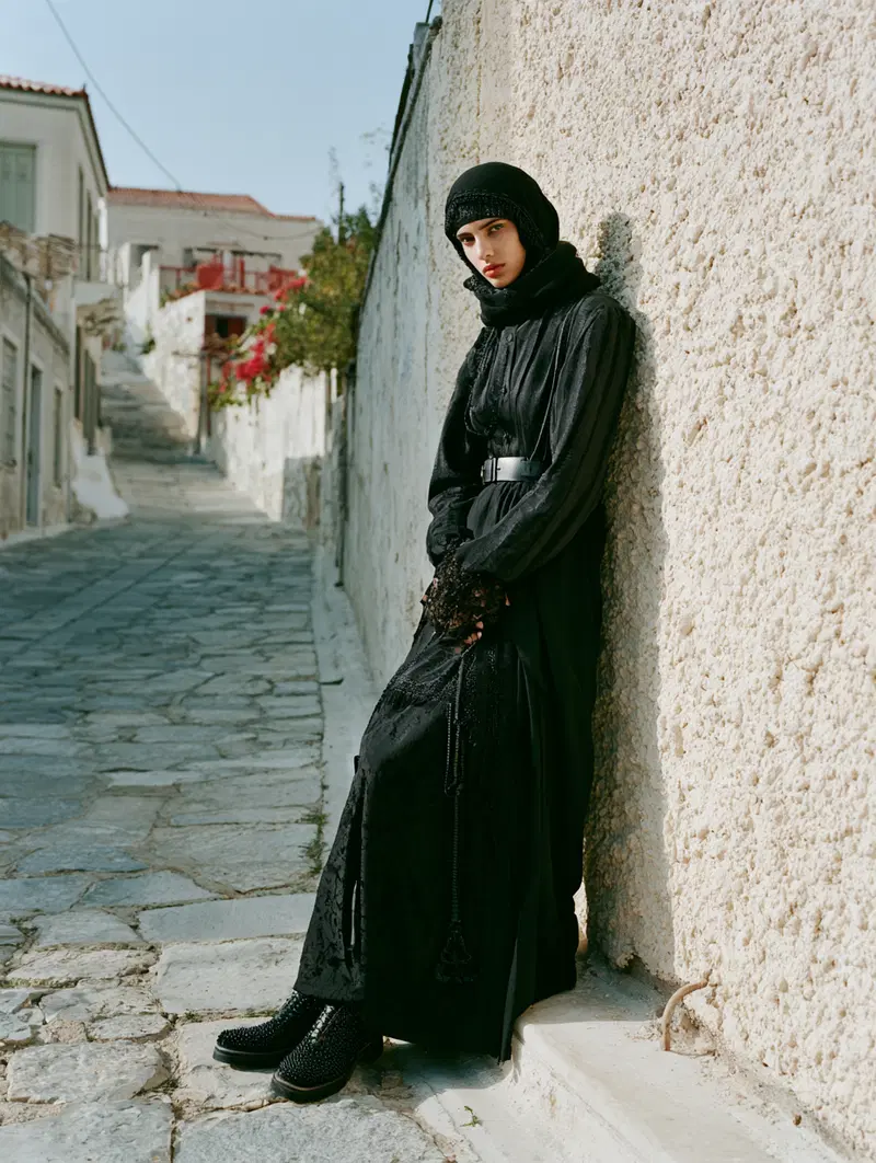 Elegant modern portrait of a woman in black attire on stone street