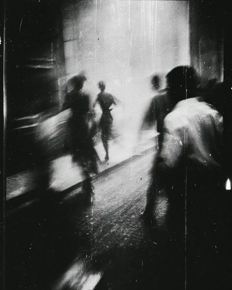 Abstract black and white photograph capturing blurred human figures in motion