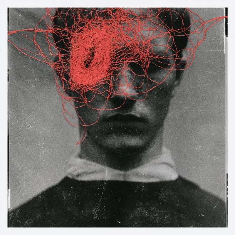 Black and white portrait with abstract red thread entanglement over face