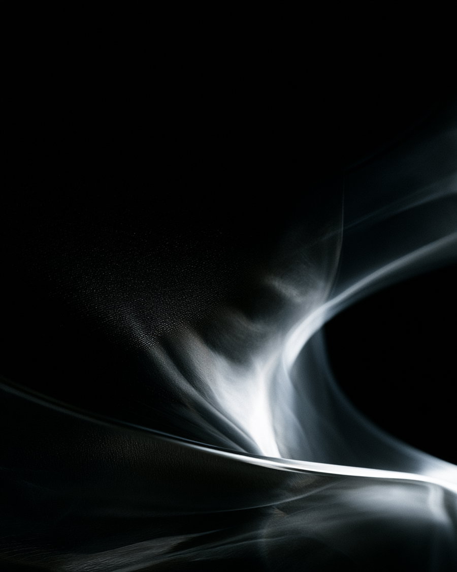 Abstract composition of soft, flowing white light patterns on a black textured background creating smooth wave-like forms