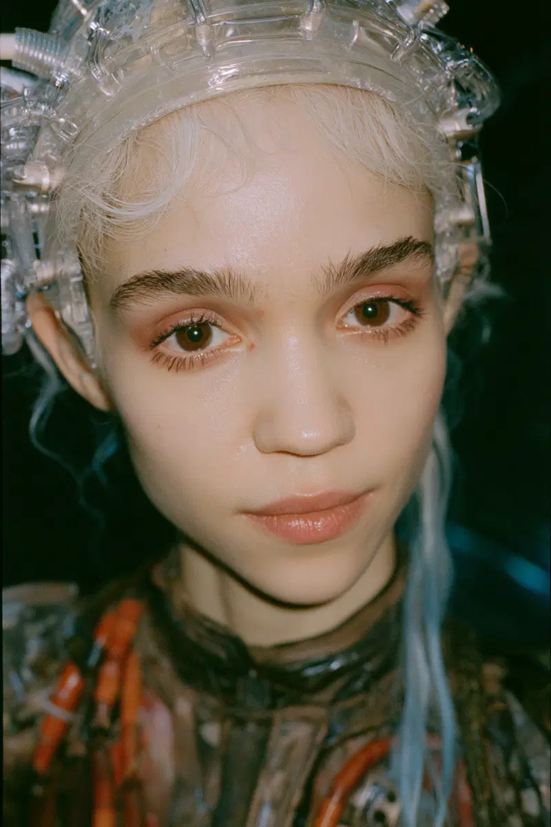 Close-up portrait of a person with cyberpunk style accessories and pale makeup