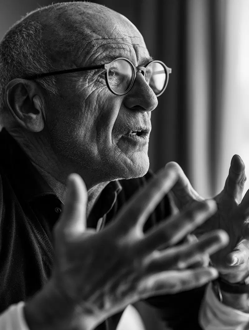 Black and white portrait of an elderly man speaking with expressive hands