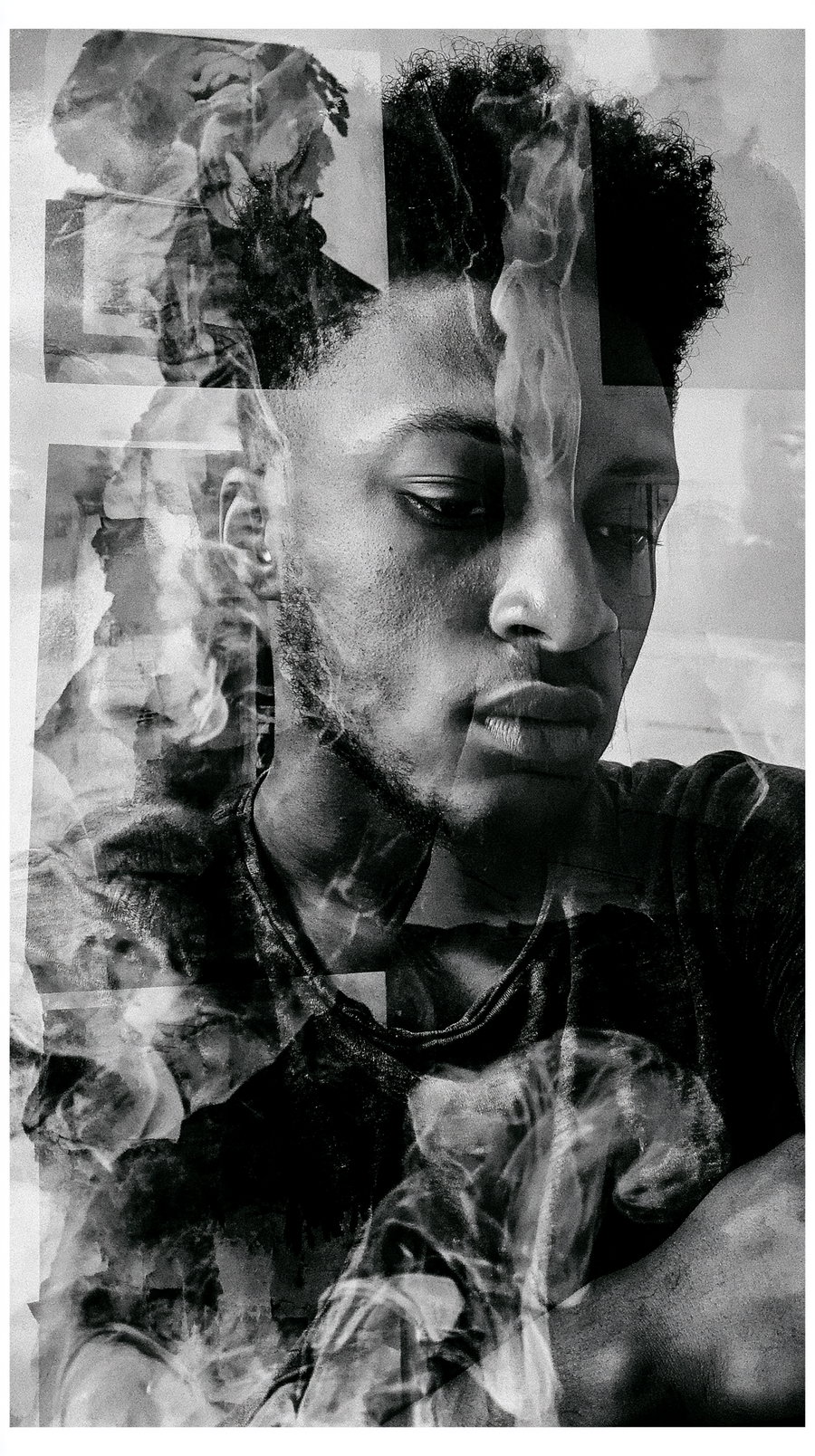 Black and white image of a man's face and upper body with an expression of contemplation, overlaid with translucent smoke effects creating a layered texture.