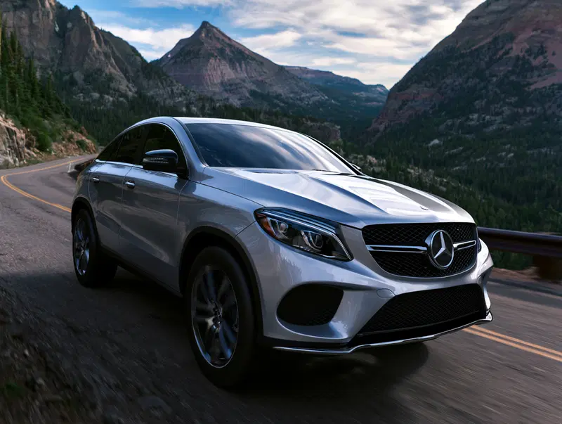 Silver Mercedes SUV Driving on a Mountain Road with Scenic Views