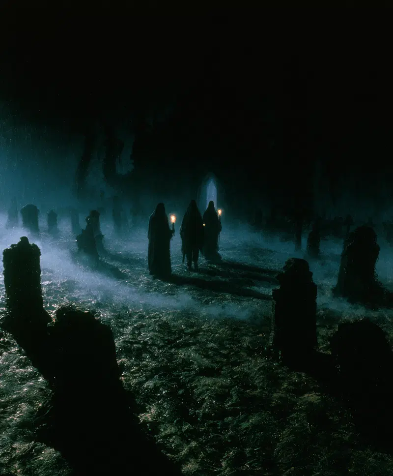 Eerie dark fantasy scene with cloaked figures and misty graveyard