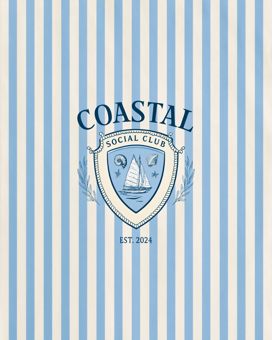 A design featuring a blue and cream vertical striped background with a shield emblem in the center. Inside the shield is a sailboat on water, seashells, and starfish, with text above reading Coastal Social Club and EST. 2024 below, decorated with leafy branches.