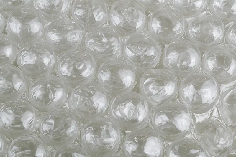 Close-up texture of transparent bubble wrap with light reflections
