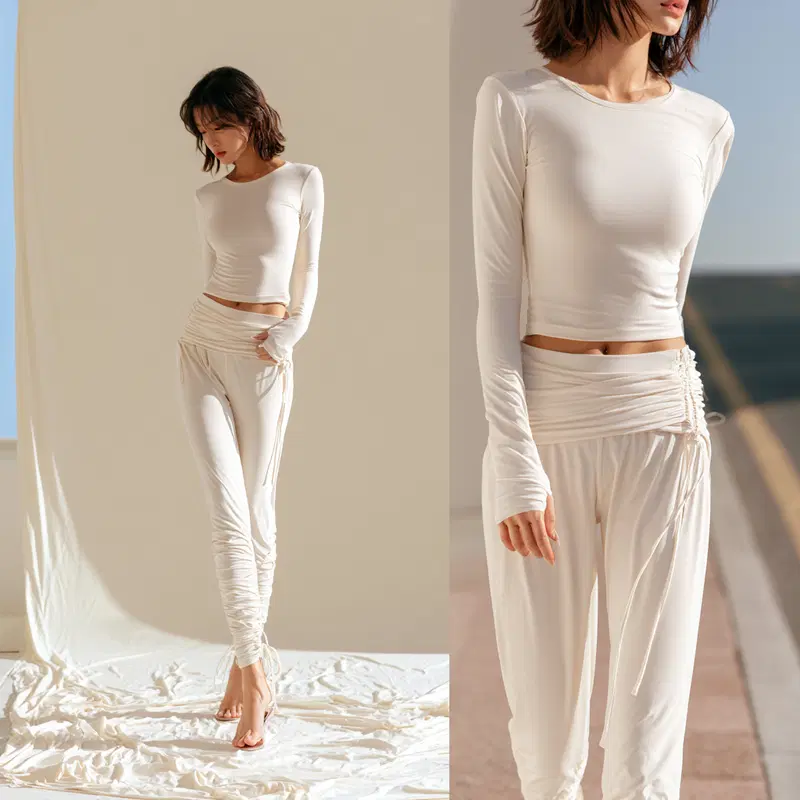 Elegant minimalistic white outfit featuring ruched trousers and fitted top