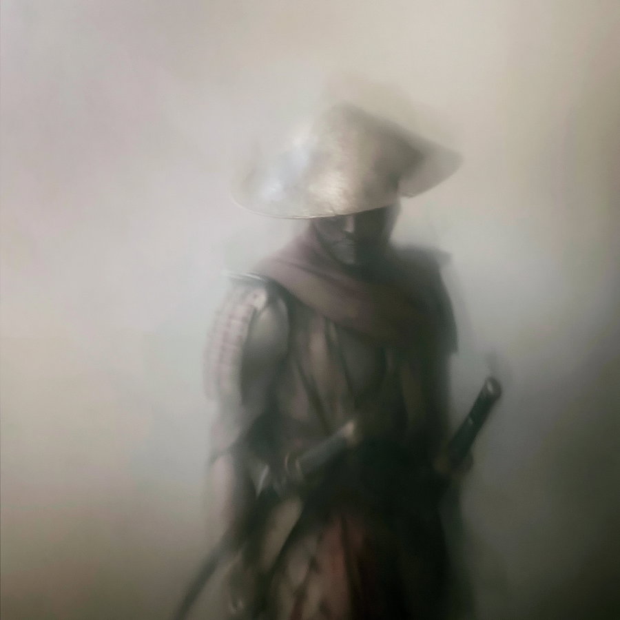 A dark, misty image of a warrior wearing armor, a wide-brimmed hat, and a scarf, holding a sheathed sword, with their face partially obscured.