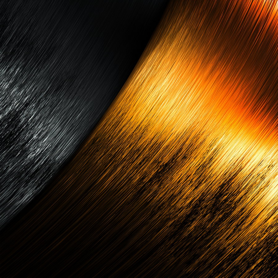 A close-up abstract image showing streaks of metallic black and golden orange colors flowing diagonally