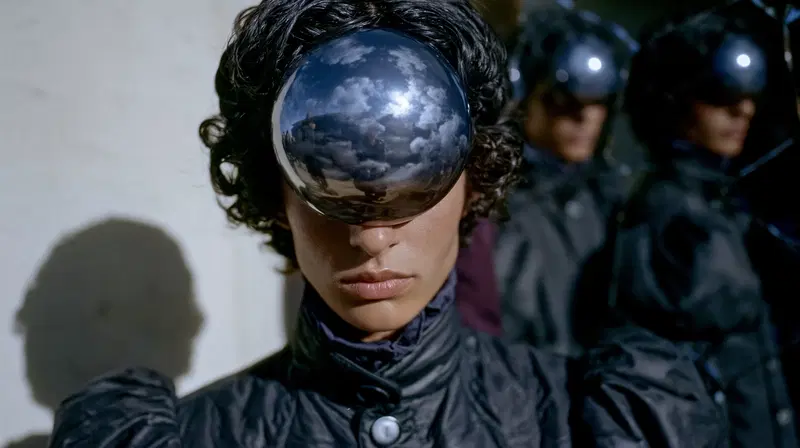 Futuristic fashion with reflective sphere visor accessory on model