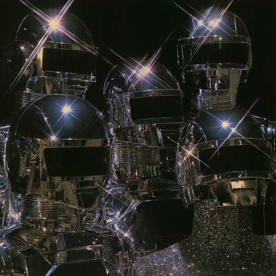 Five individuals wearing shiny metallic chrome helmets and suits, with light reflections creating star-like glints on their surfaces, set against a dark background.