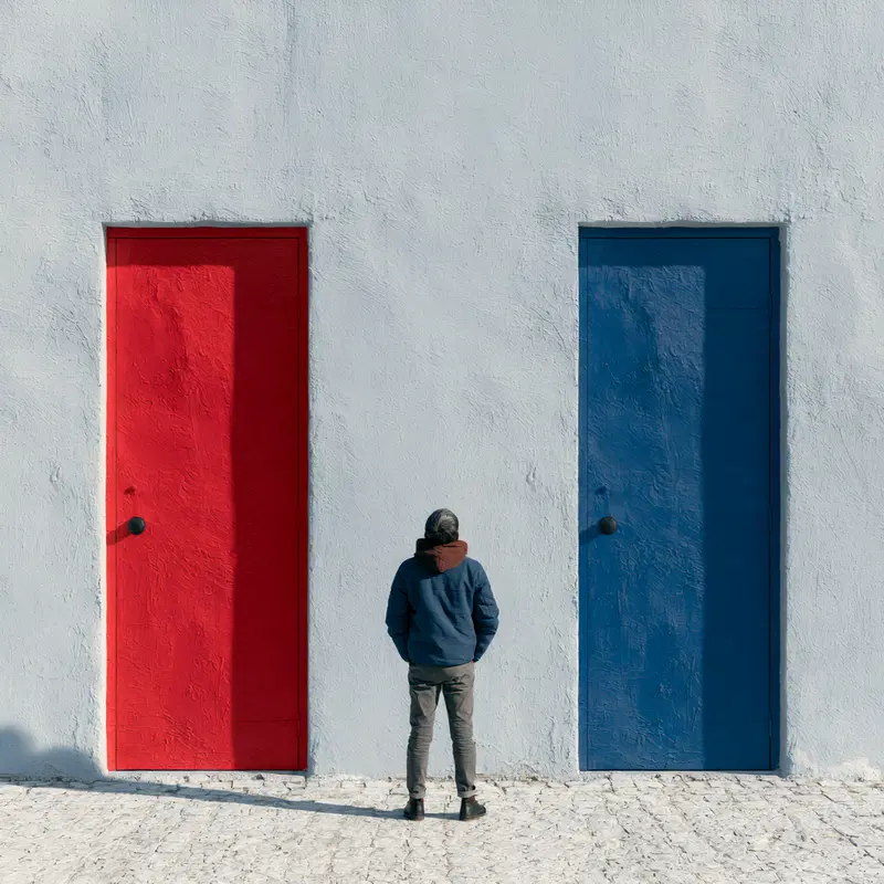 Man Standing Before Two Distinct Colorful Doors