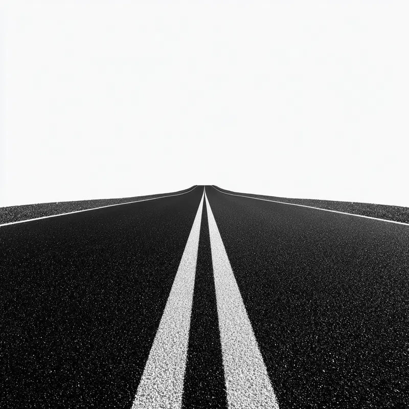 Minimalist perspective of an empty road with white lane markings