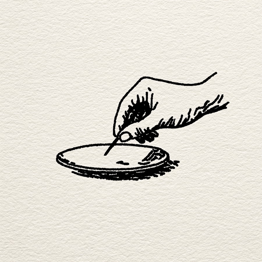 Black ink sketch of a hand holding a pencil poised above a round object on textured paper background