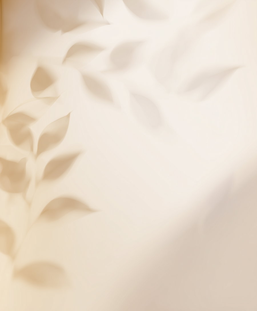 Abstract image featuring soft, blurred leaf shapes in warm beige and cream colors creating a dreamy botanical effect